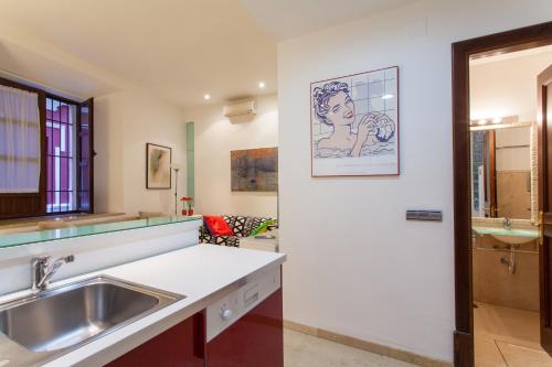 a kitchen with a sink and a counter top at Logia Sevilla in Seville