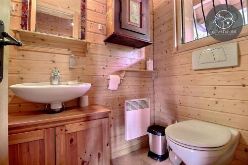 a bathroom with a white sink and a toilet at Chalet Arwi in Ovronnaz