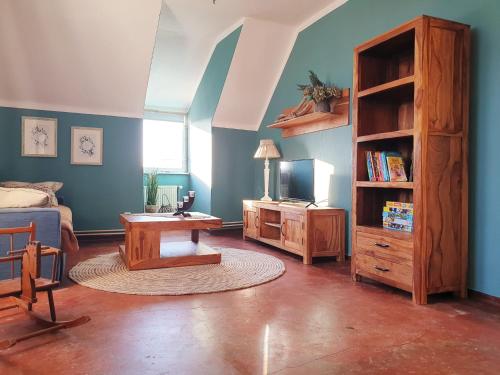 a living room with a table and a book shelf at Bensdorfer Mühle - Auszeit in Brandenburg in Bensdorf