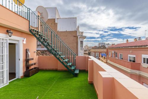 a balcony with green grass on a building at H-A Hotel Trebol in Málaga
