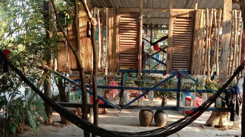 a hammock in front of a wooden building at Bunyong Homestay in Siem Reap