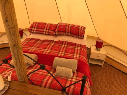 a bedroom with a bed in a tent at Cox Hill Glamping Benson in Truro