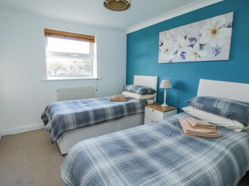 A bed or beds in a room at Blackwater Meadows