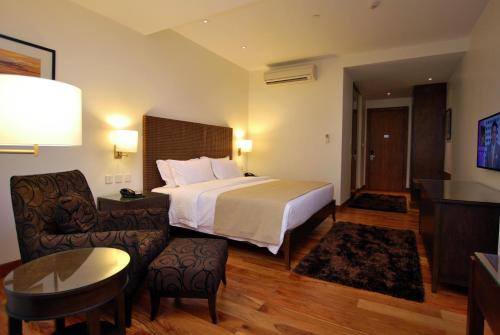 Кровать или кровати в номере City Garden Grand Hotel