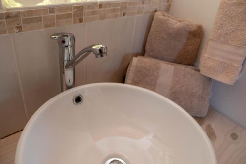 a white toilet in a bathroom with a sink at Kormorant in Gansbaai