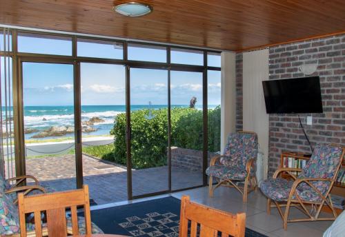 a living room with a view of the ocean at Kormorant in Gansbaai