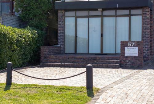 a brick building with a sign in front of it at Kormorant in Gansbaai