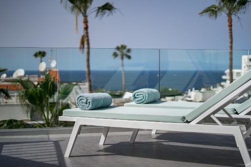 a white bench with two pillows on top of a balcony at Ocean View Luxury Apartment PH014 in Adeje