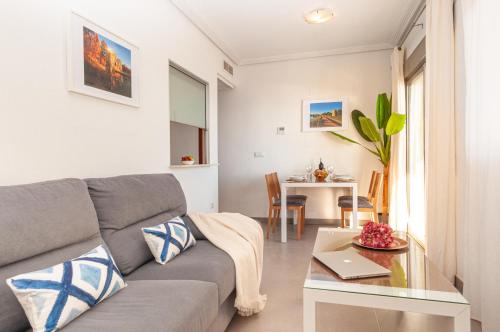 a living room with a couch and a table at Apartamentos Turisticos Rent Guardamar in Guardamar del Segura