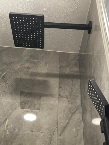 a glass shower with a bench in a bathroom at Da Vinci Guest House & Guest Parking, A Real Gem in Crawley