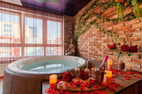 a bathroom with a tub with roses and candles at Jacuzzi - Love - BDSM - Extra Luxury - EV chargger - Valentine's Day - Red Room - Flexible SelfCheckIns 28 in Zagreb