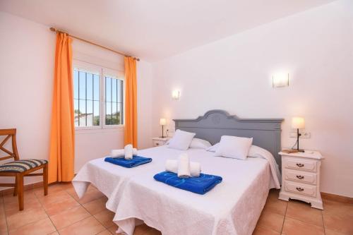 a bedroom with two beds with blue towels on them at Monte Amarillo in Jávea
