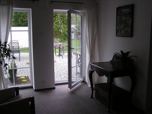 a room with a piano and a door to a patio at Alt pension in Prague
