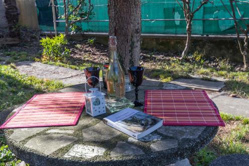 a table with a bottle of wine and a book at Casa Stella Malpensa in Cassano Magnago