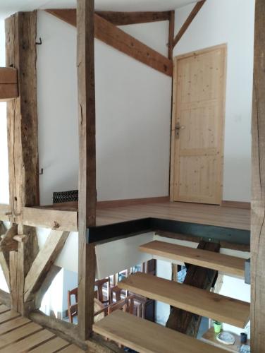 a room with wooden floors and a door at La Coquille in Pouillon