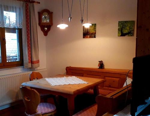 a dining room with a table and a clock at Frühstückspension Eibenstein in Eibenstein