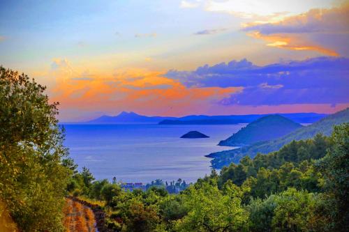 a view of a body of water at sunset at Skopelos Mortero Cottage in Panormos Skopelos