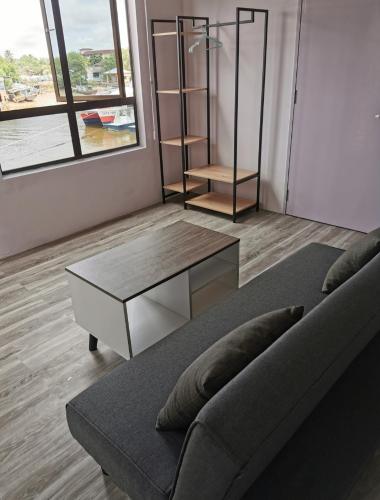 a living room with a couch and a coffee table at MersingFirstFloor丰盛港二楼民宿 in Mersing