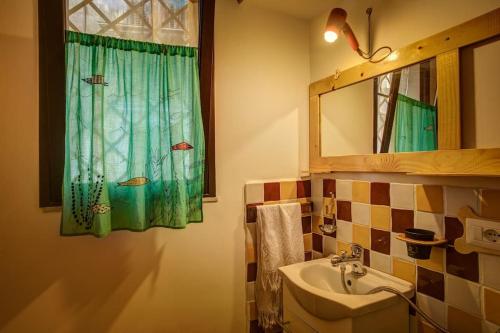 a bathroom with a sink and a mirror at Casa Verde in Catania