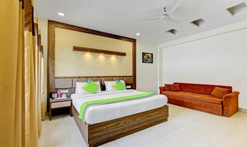 a bedroom with a bed and a couch at Raj Darbar - 10 Meter From Golden Temple in Amritsar