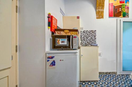 a microwave sitting on top of a refrigerator at Sally Port 32 in Valletta