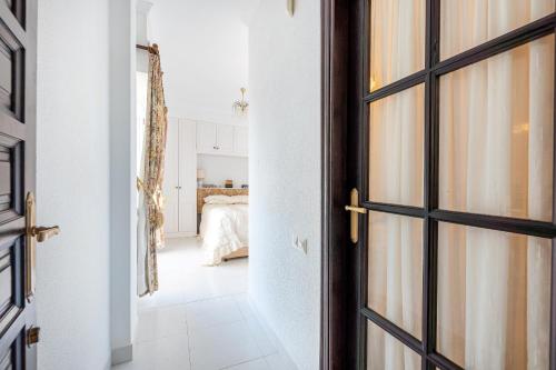 an open door to a bedroom with a bed at Villa with Stunning Views & Private Pool in Mijas Costa