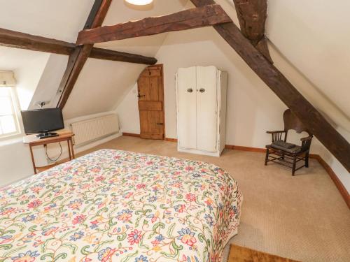 Cornhill-on-tweed的住宿－The Coach House，阁楼上的卧室配有一张大床