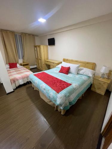 Cama o camas de una habitación en Hogar Cuencano Hostal & Suites