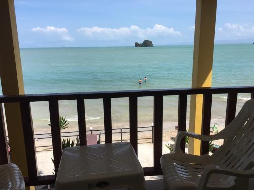 a balcony with a view of the ocean and a beach at Ma Lay Resort in Ban Pheng Krong
