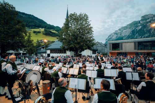 an orchestra playing in front of a crowd of people at Gabriela Apartments in Mellau