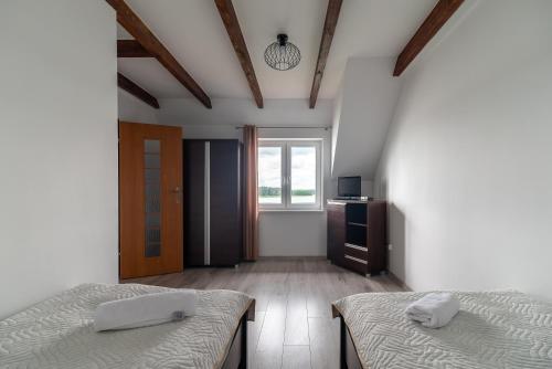 1 Schlafzimmer mit 2 Einzelbetten und einem Fenster in der Unterkunft WDZYDZANIN in Wdzydze Tucholskie