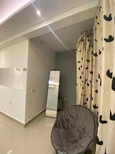 a room with a chair and a curtain with bats on it at Privada tipo cabaña Con amplio patio in Santiago de los Caballeros