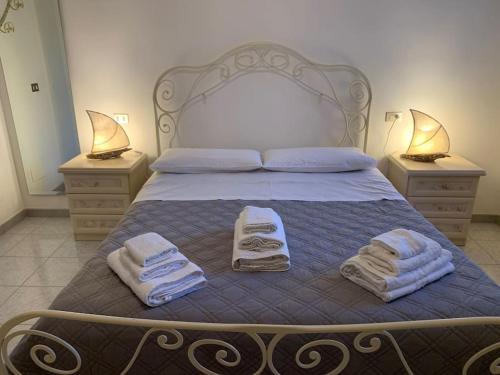 a bedroom with a bed with towels on it at Villa dei Gelsi in Leporano Marina