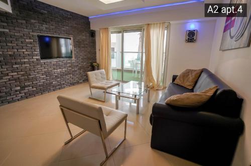 a living room with a couch and a table at Palmore Resort apartments in Eilat