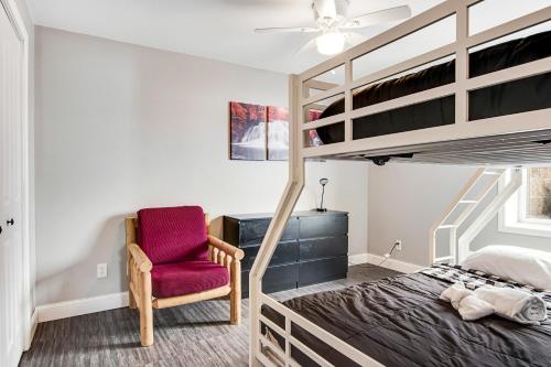 a bedroom with a bunk bed and a red chair at LightHouse Cove #208 in Wisconsin Dells