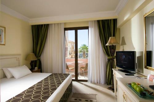 a hotel room with a bed and a television at IL Mercato Hotel & Spa in Sharm El Sheikh