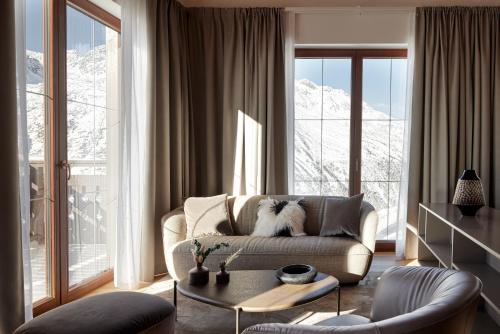 a living room with a couch and a table at TOP Hotel Hochgurgl in Hochgurgl