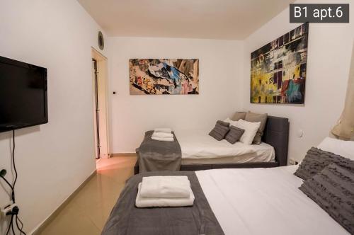 a small room with a bed and a tv at Palmore Resort apartments in Eilat