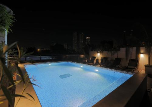 a large swimming pool at night on a building at Hotel Palermitano by DOT Boutique in Buenos Aires