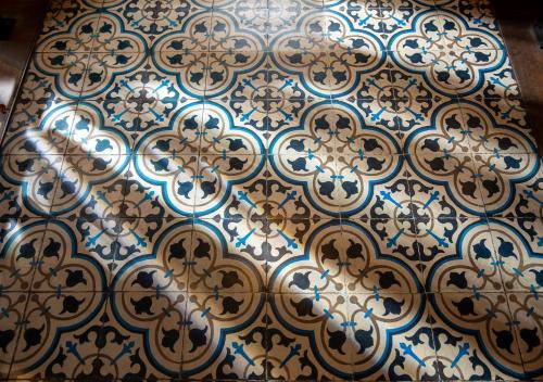 a tiled floor with blue and white patterns on it at Hotel Palermitano by DOT Boutique in Buenos Aires