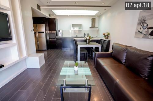 a living room with a couch and a table at Palmore Resort apartments in Eilat