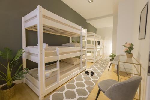 a room with three bunk beds in a room at The Harbour Apartment 1 in Hamburg
