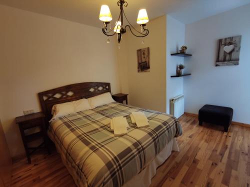 a bedroom with a bed with two books on it at Inmocyma La terraceta de Linsoles-Valle de Benasque in Benasque