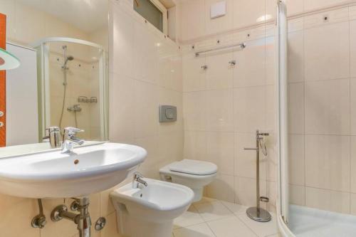a bathroom with a sink and a toilet and a shower at Cencherle in Novigrad Istria