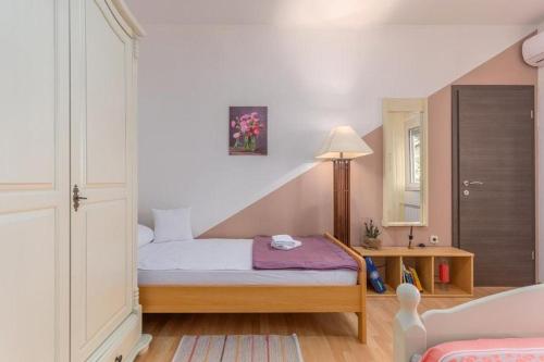 um pequeno quarto com uma cama e um espelho em Apartment David em Novigrad Istria
