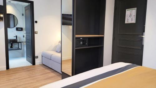 a small room with a bed and a mirror at Star Champs-Elysées in Paris