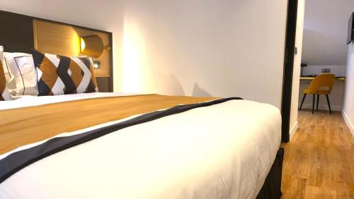 a hotel room with a bed and a desk at Star Champs-Elysées in Paris