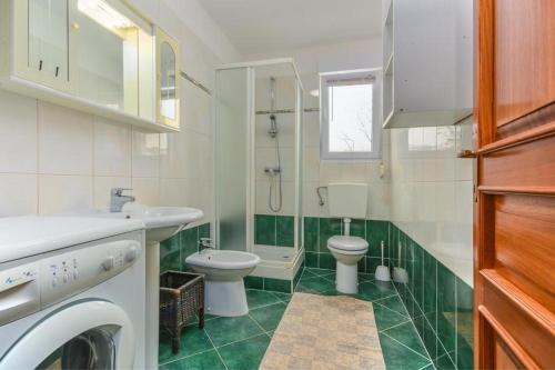 a white bathroom with a toilet and a sink at Apartment Nena in Novigrad Istria