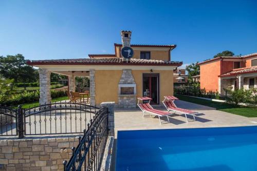 a villa with a swimming pool and a house at Villa Mateja in Karigador