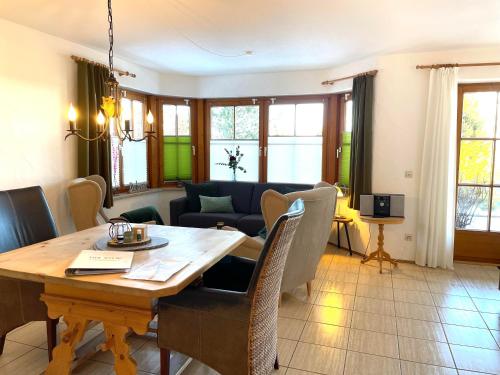 a living room with a table and a couch at Landhaus Obermaiselstein "THE VIEW" in Obermaiselstein